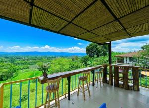 a balcony with chairs and a view of the mountains at Hotel La Casona Quindío Eje Cafetero in Montenegro