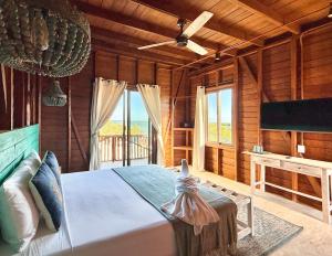 a bedroom with a bed with a ceiling fan at Krak-Inn Holbox - Pet Friendly in Holbox Island