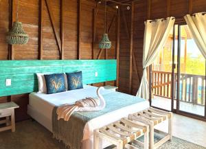 a bedroom with a bed with a swan on it at Krak-Inn Holbox - Pet Friendly in Holbox Island