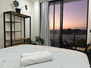 a bedroom with a bed and a large window at Casa Elio - Bed and Breakfast in San Juan del Sur +21 photos