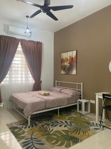 a bedroom with a bed and a ceiling fan at Impian May Homestay 1,Taman Koperat Putera in Kampung Raja
