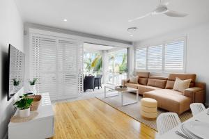 a living room with a couch and a table at 19 Colonial in Noosaville