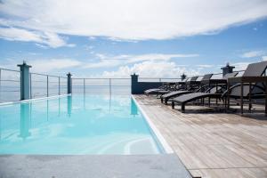 a swimming pool on the deck of a cruise ship at Palmbeach Resort & Spa Mactan, Cebu in Mactan