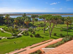 an aerial view of a park with palm trees and the ocean at Hotel Quinta do Lago in Quinta do Lago