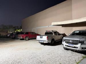 a group of cars parked in front of a building at Hotel 44 Oliveira in Goiânia