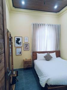 a bedroom with a bed and a window at a Hue Homestay in Hue
