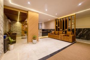a lobby with two couches in a building at MAXX Elite in Gurgaon
