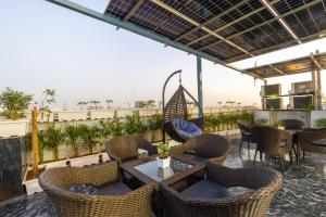a patio with tables and chairs on a roof at MAXX Elite in Gurgaon