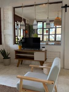 a living room with a piano and a chair at Cardedeu Residence Cangrejera in La Libertad