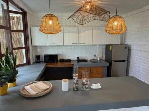 a kitchen with white cabinets and a counter top at Cardedeu Residence Cangrejera in La Libertad +7 photos