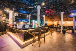 a bar in a large room with chairs and tables at Northern Cove Penang in Tanjung Bungah