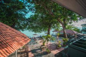 an overhead view of a resort with trees and a beach at Northern Cove Penang in Tanjung Bungah