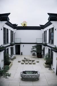 a courtyard with a fountain in the middle of a building at Wuzhen FortuneCourt Hotel in Jiaxing