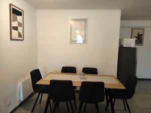 a dining room with a table and chairs at Ô Bon Goût in Bourges
