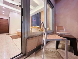 a room with a table and a chair and a window at Oakleaf Hotel & Resort - A Classic Rooms & Prime Location Near Library Chowk in Mussoorie