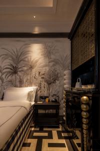 a bedroom with a bed and a wall with palm trees at Hui-TEXACO in Gulang Yu +8 photos