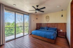 a bedroom with a bed and a ceiling fan at Master Jungle Penthouse with Large Private Terrace - Santuario Hotel Boutique in Chemuyil +62 photos
