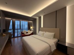a bedroom with a bed and a desk and a chair at The Aerie in Kuala Lumpur +17 photos