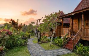 a house with a garden in front of it at Sirya Farm House in Meliling