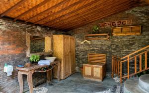 a bathroom with a sink in a brick wall at Sirya Farm House in Meliling