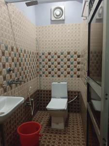 a bathroom with a toilet and a sink at Hotel Ayodhya in Ayodhya