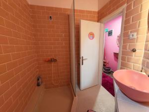 a bathroom with a pink sink and a shower at Barbie in Veria +8 photos
