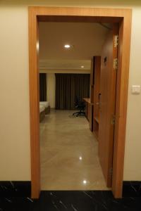 a door leading into a hotel room with a bedroom at Hotel Shubham Prestige in Surūrnagar