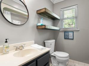 a bathroom with a sink and a mirror and a toilet at Sunset Cove - Large Cove, Gorgeous Sunsets, Amenities Galore! in Bremen +23 photos