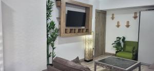 a living room with a tv on a wall at Casa del Pilar in Pinto