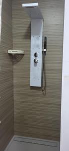 a bathroom with a shower with a phone on the wall at Casa del Pilar in Pinto +20 photos