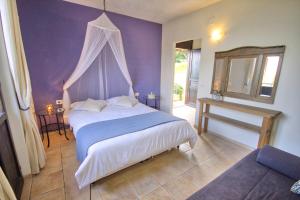 a bedroom with a bed with a purple wall at La Dolce Vallata in Montefiore dellʼAso +89 photos