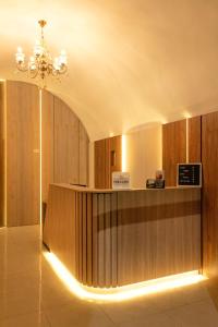 a lobby with a reception desk and a chandelier at Hotel Inkalma Santa Marta in Arequipa