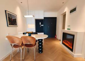 a living room with a table and chairs and a fireplace at Merit黄浦 Bright and Modern 2Bed Condo unit in downtown Shanghai in Shanghai