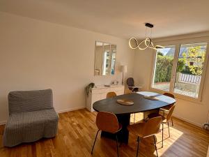 a living room with a dining room table and a chair at Maison Cosy à Chartres in Chartres