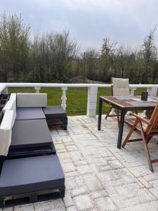 a patio with a table and a table and a chair at Ladislaus Garden Suites in Cegléd
