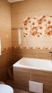 a bathroom with a bath tub with a flower shower curtain at Дарина in Chornomorsk +103 photos
