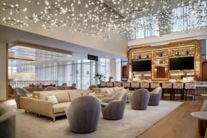 a hotel lobby with couches and a bar at HALL Arts Hotel, Dallas, Autograph Collection in Dallas