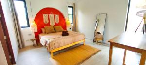 a bedroom with a bed with a cat sitting on it at Samma Villas - Ruby Villa - 2 BDR & private pool in Ko Phangan +35 photos