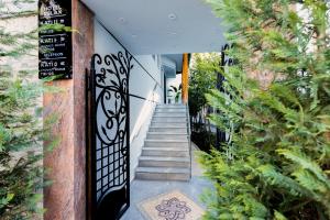 a staircase leading up to a building with a wrought iron gate at Hotel Relax City Center in Tirana