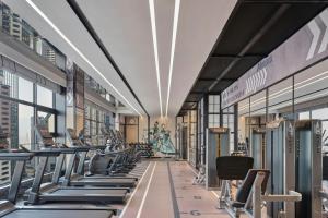 a gym with rows of treadmills and machines at Four Points by Sheraton Chongqing in Chongqing