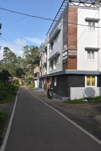 an empty street in front of a building at Bihotels And Resorts in Yercaud