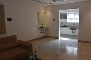 a living room with a couch and a sink at Bihotels And Resorts in Yercaud