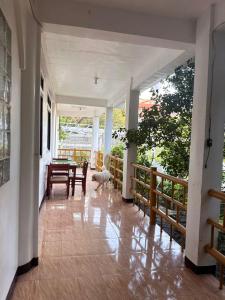a dog is standing in the hallway of a house at Mabel's Garden Stay in Puerto Galera