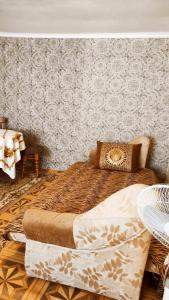 a bedroom with a bed and a wall at Дарина in Chornomorsk
