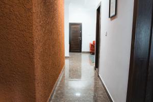 a hallway with a wall and a hallway with a door at Spacious 3-Bedroom in Central Ikeja in Ikeja