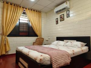 a bedroom with a large bed with a window at UDUPI HOMESTAY - Cottage House - Dendoorkatte, Udupi in Udupi +78 photos