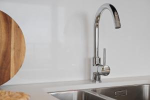 a kitchen sink with a chrome kitchen faucet at Zilt 15 in Ostend +31 photos
