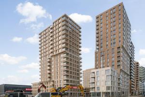 two tall buildings in a city with construction equipment at Zilt 15 in Ostend