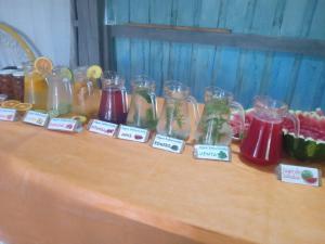 a table with many glass jars and other items on it at El Atardecer in Lunarejo