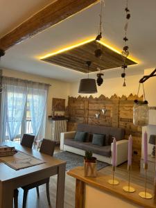 a living room with a couch and a table at Appartamento "Roby" in centro Cavalese in Cavalese